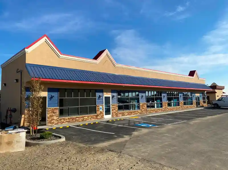 Strip retail centre with a new navy standing-seam mansard