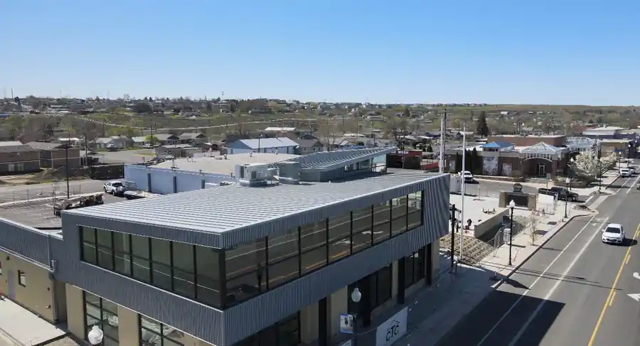 Drone view of a two-storey commercial building with corrugated metal and a flat roof