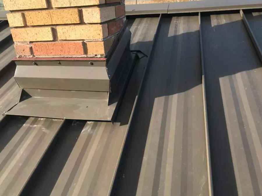 Bronze standing seam with sheet-metal chimney flashing