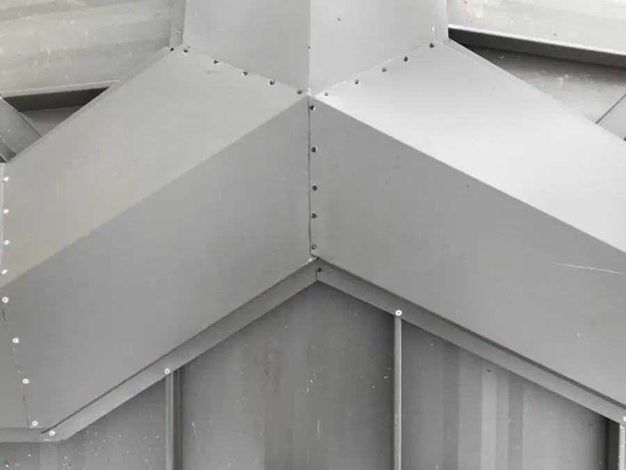 Grey metal roof at a hip and valley junction